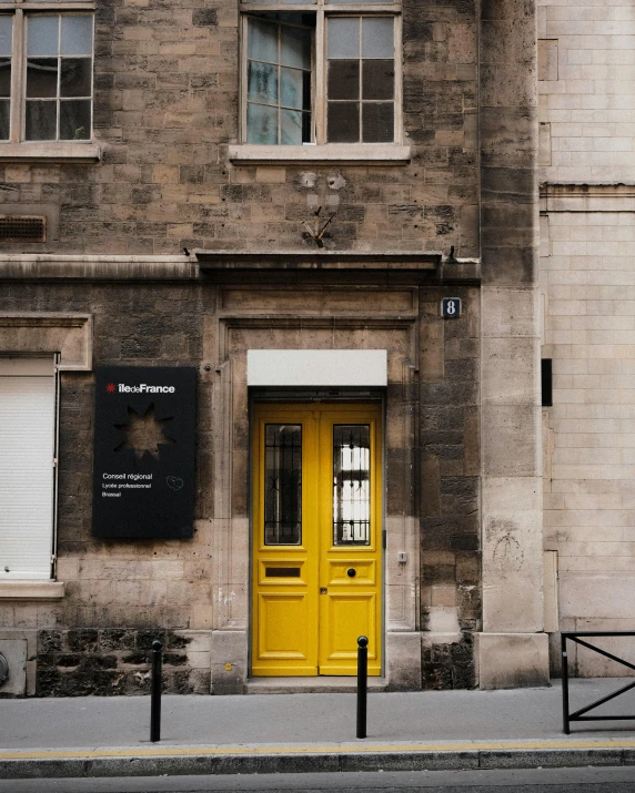 the front door to an old building is painted bright yellow