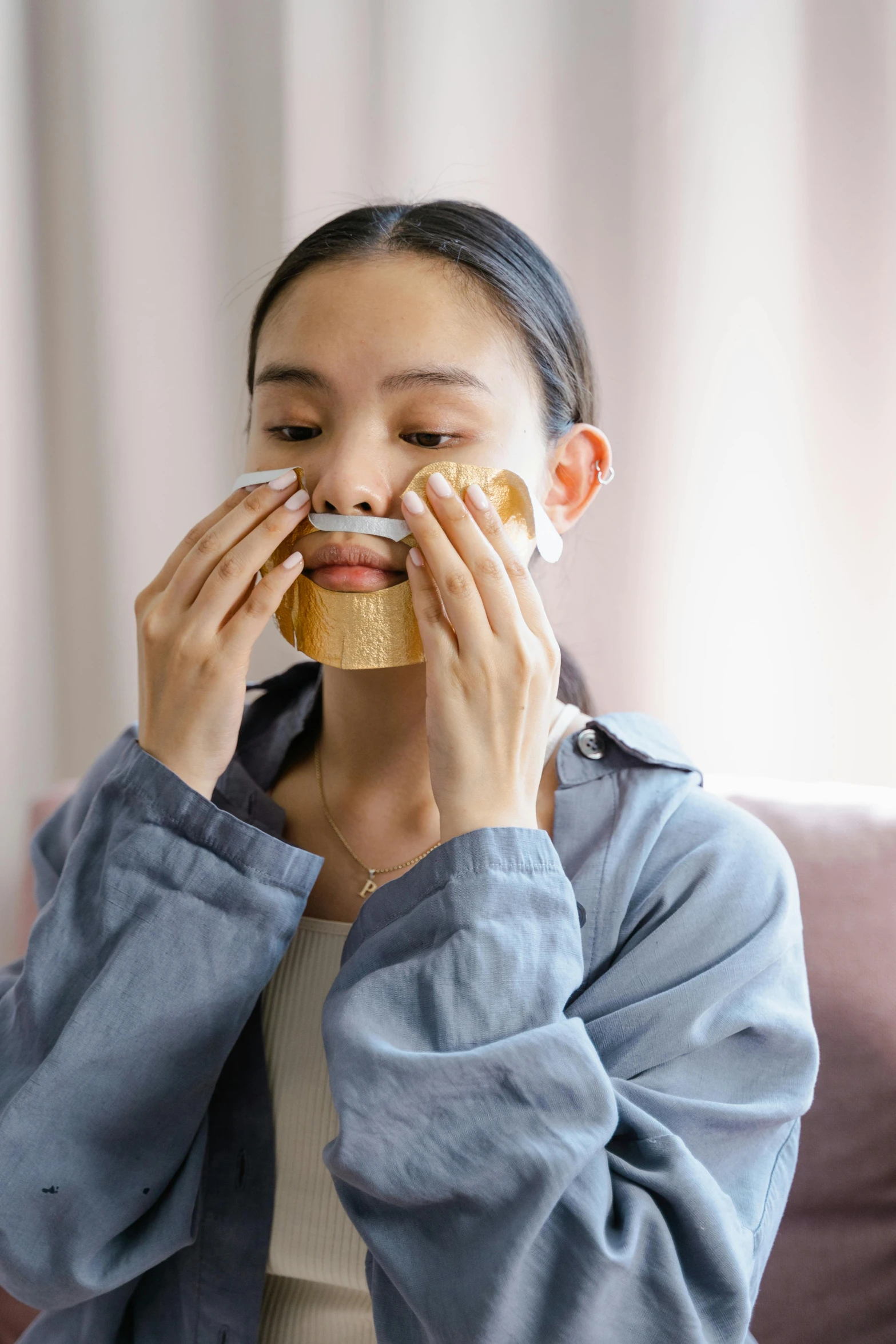 woman covering her face with a piece of cake