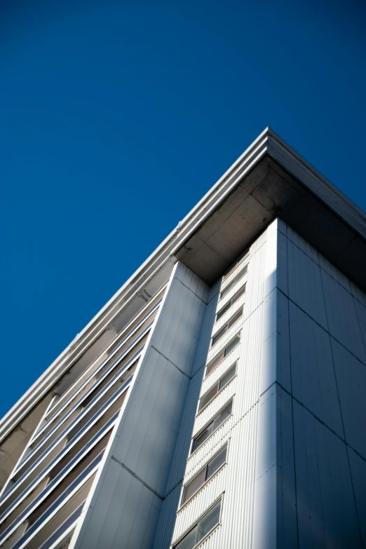 view of a tall building looking up into the sky