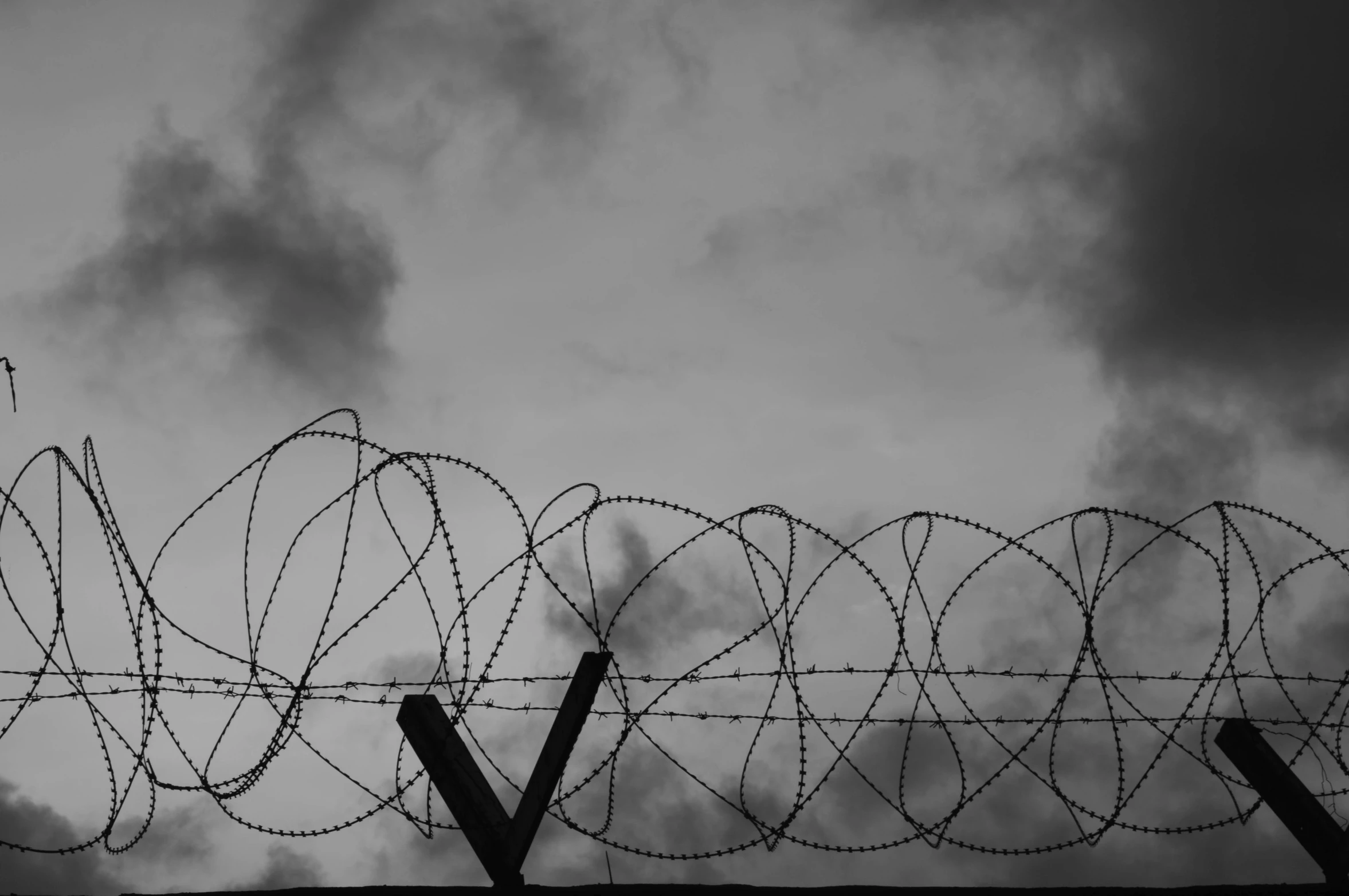 the lines of barbed wire run along this fence