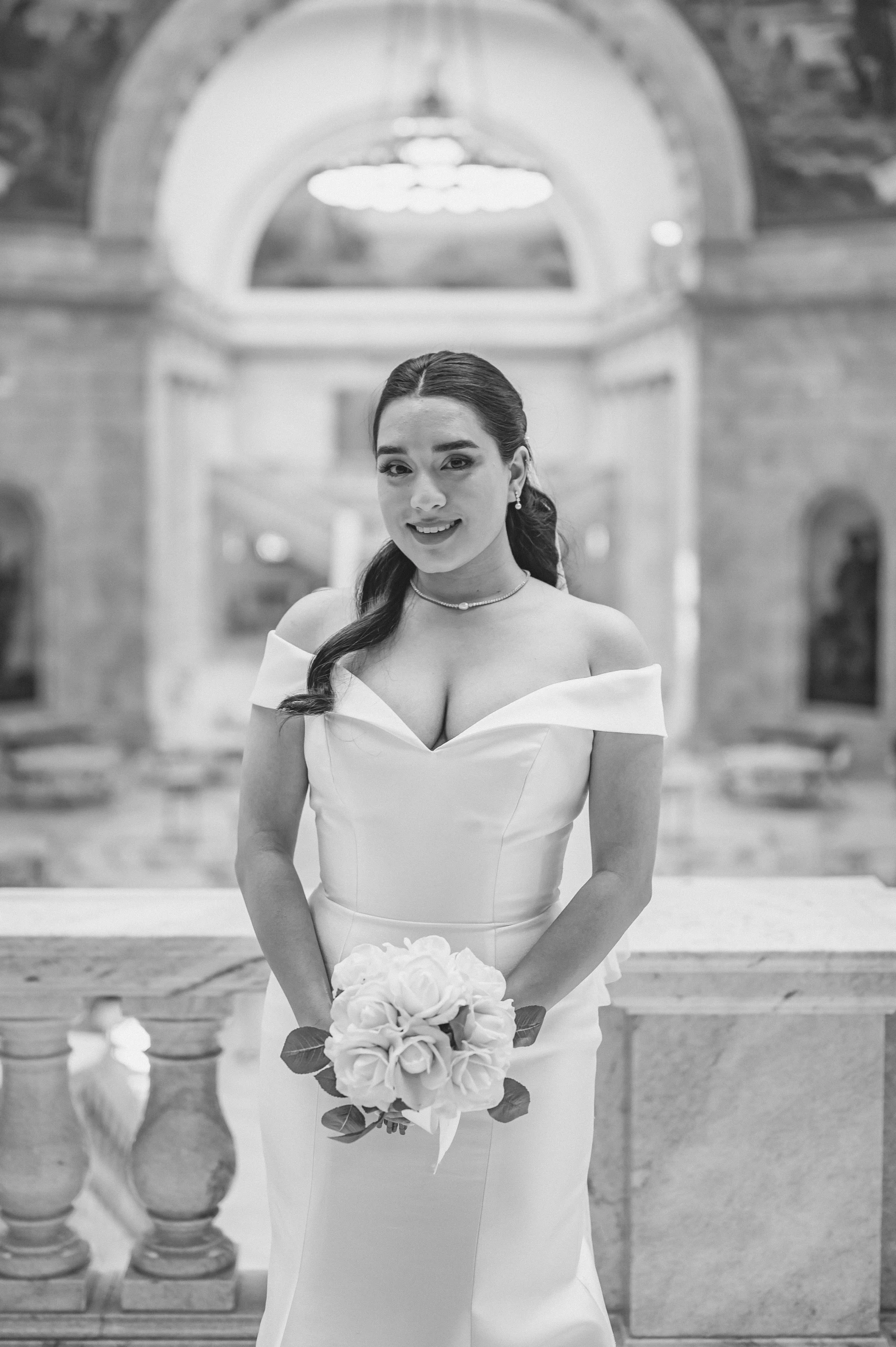 a young woman in a wedding gown posing for the camera