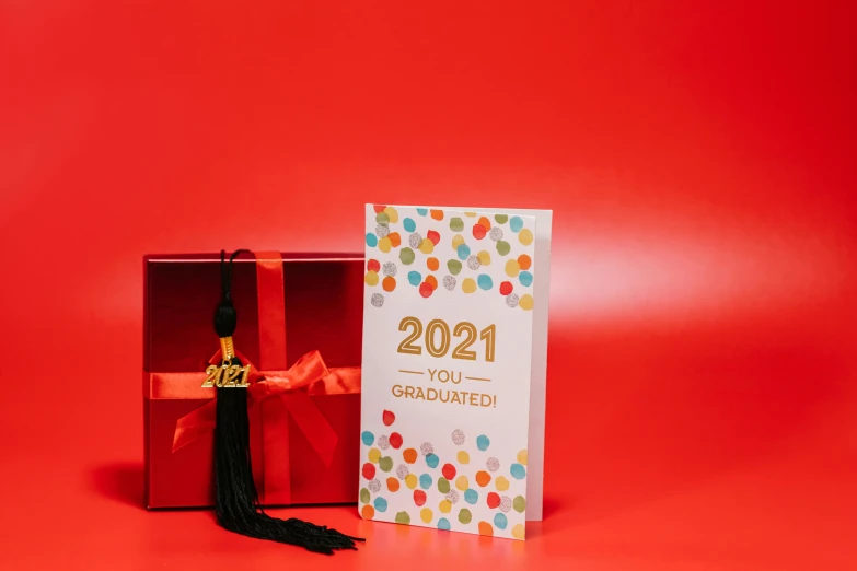 a graduation card in a red box on a red background