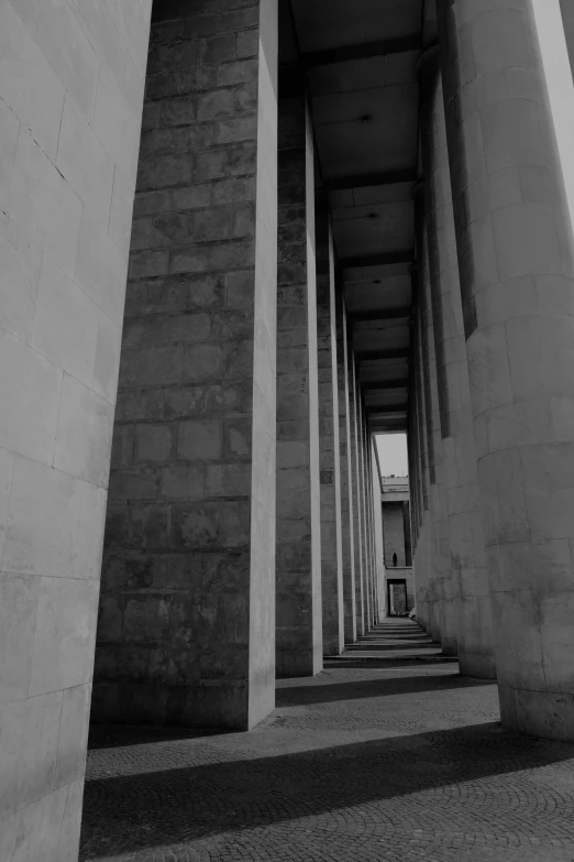 black and white pograph of cement pillars and concrete pavement