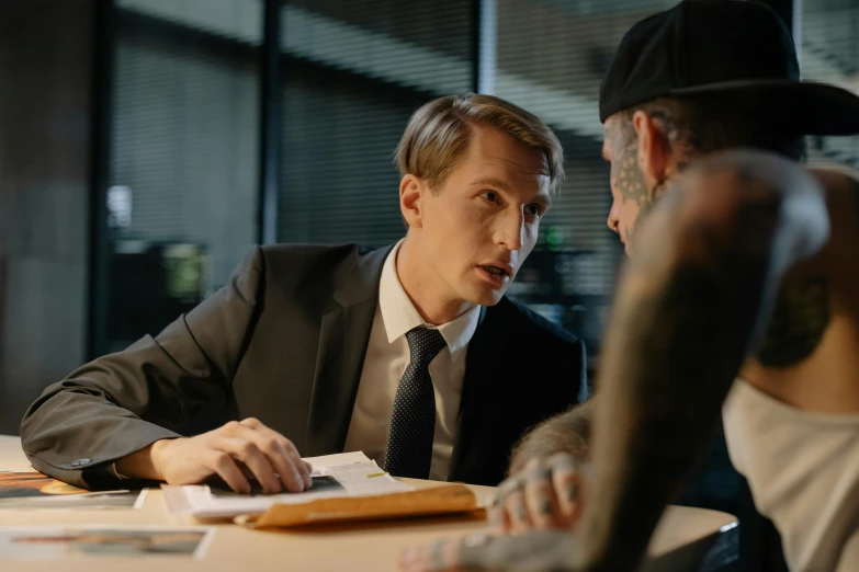 a man in a suit talking with another person