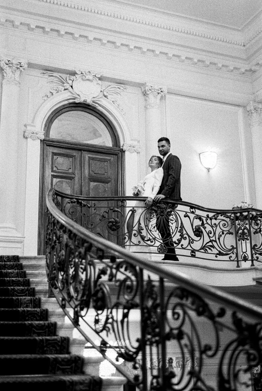 a man in a suit is standing on a staircase