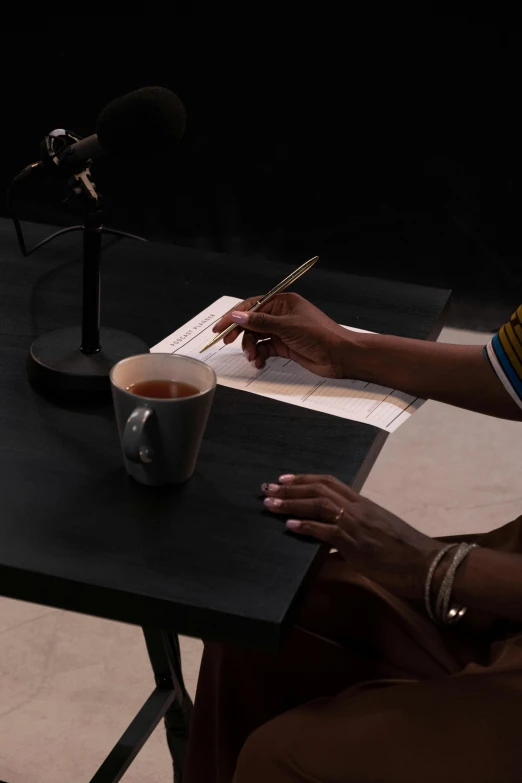 a black woman in a yellow striped shirt and a microphone