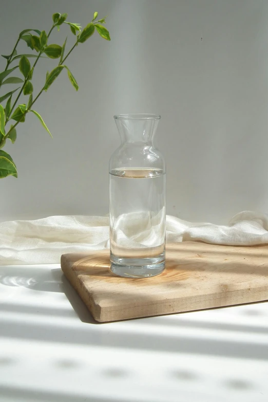 a water jug next to a glass filled with water