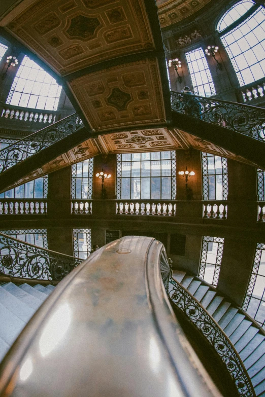 an indoor building that has many windows and stairs