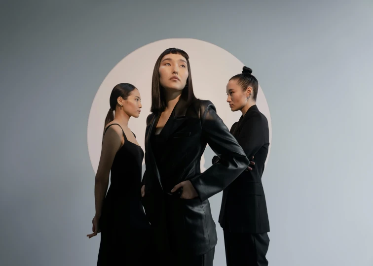 three female models posing with their hands on their hips