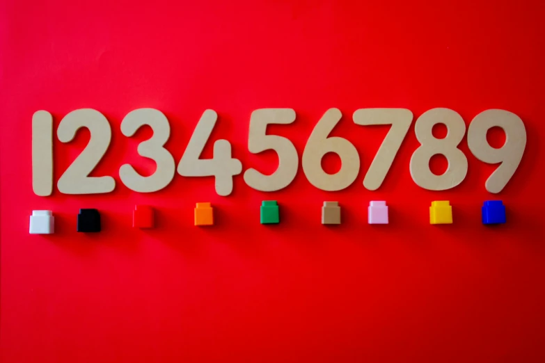a number on a red surface with different colored ons