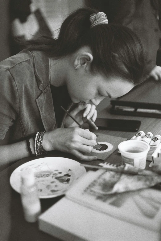 a woman is eating while taking some food from a plate