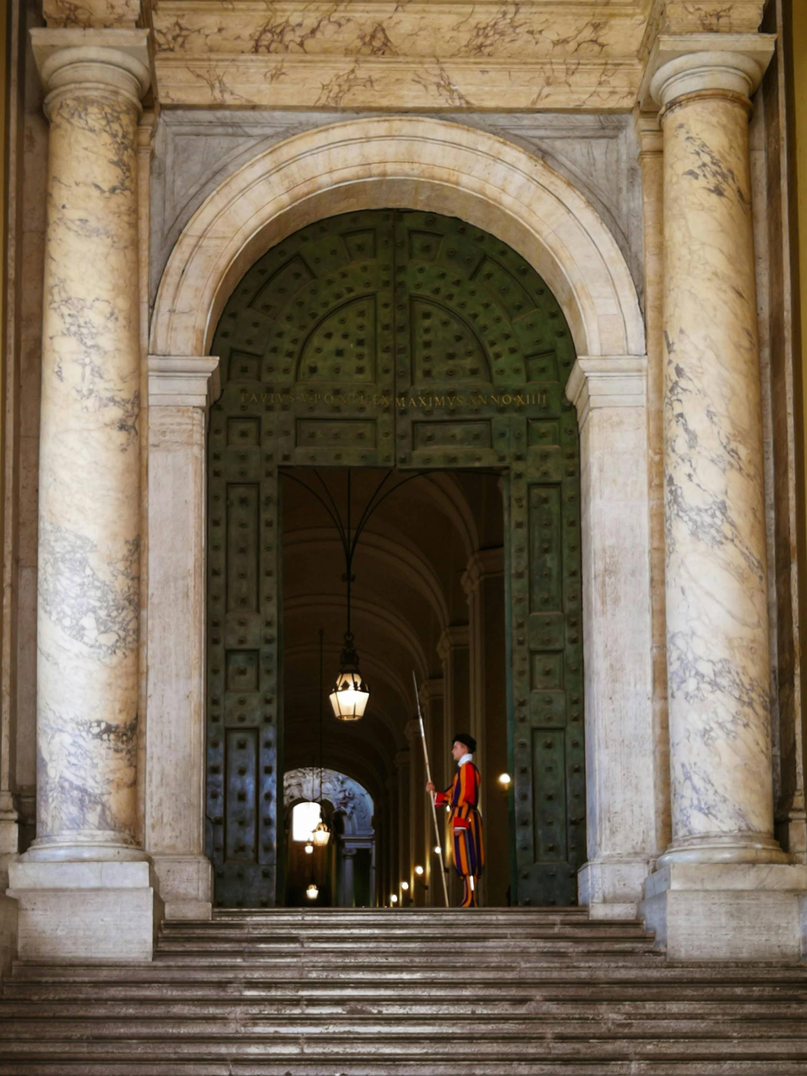 an entrance with a man in red and light fixtures