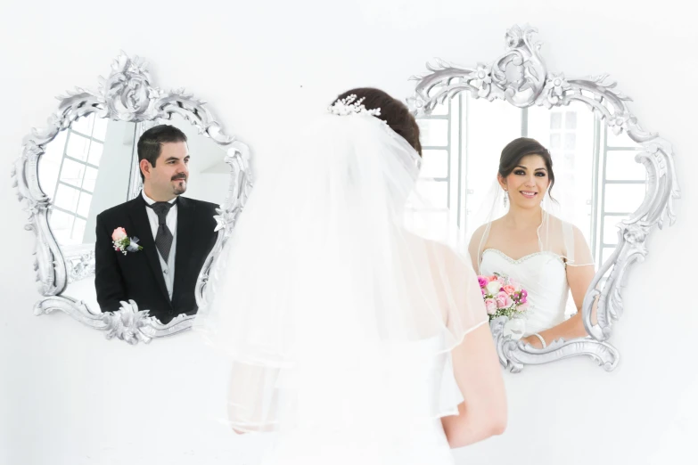 a man and a woman that are in front of a mirror