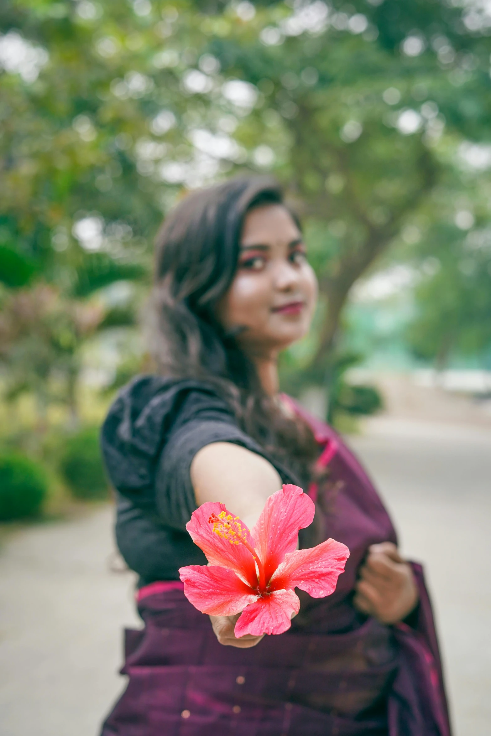 the woman is holding her pink flower