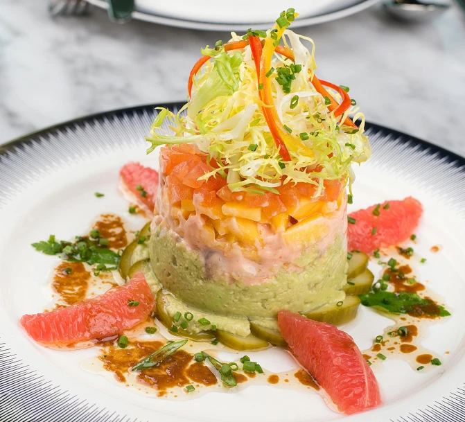 a white plate topped with a colorful food salad