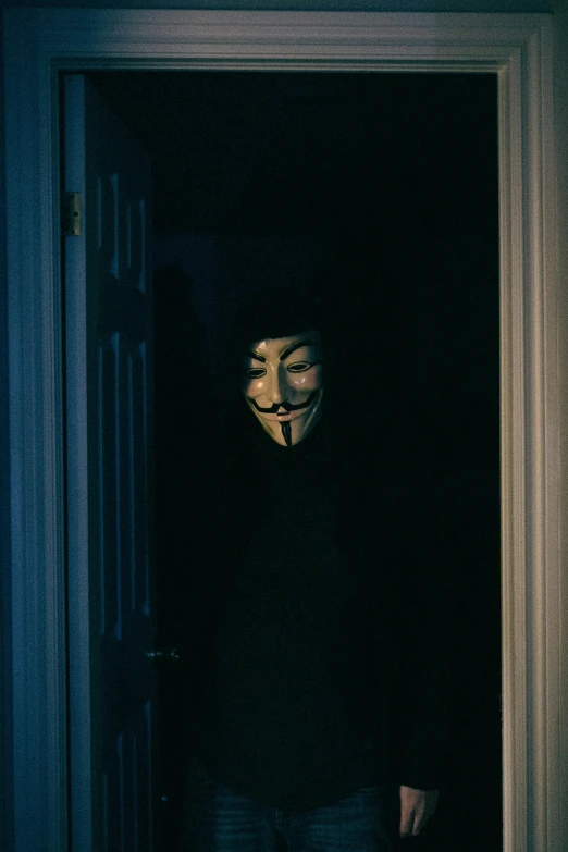 a person in a room wearing a mask