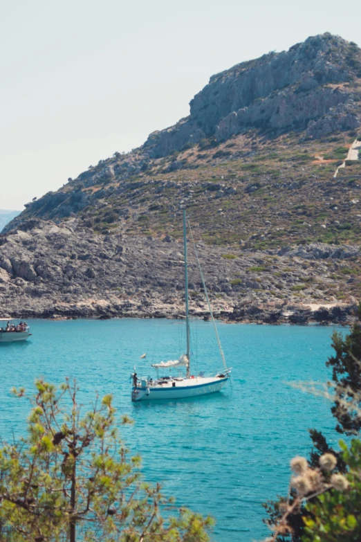 three boats are floating in the blue water