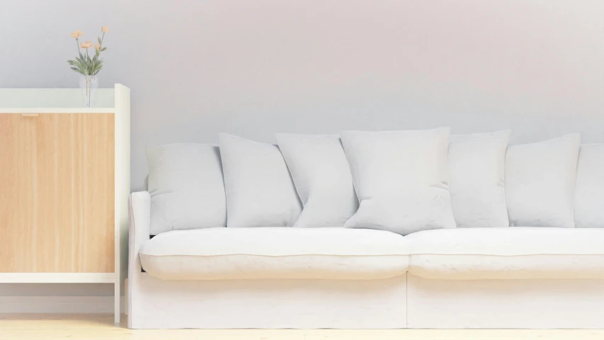 a white couch with several pillows next to it