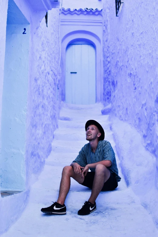 a man sitting down and looking up into the sky