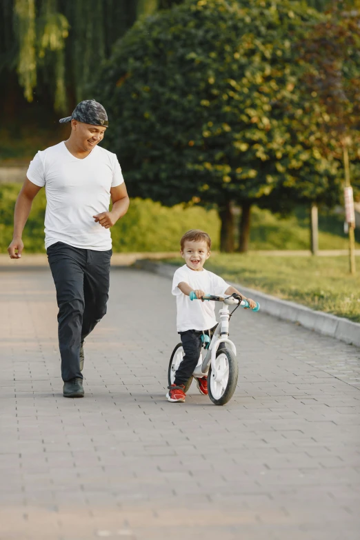 the man is hing a baby on a bike