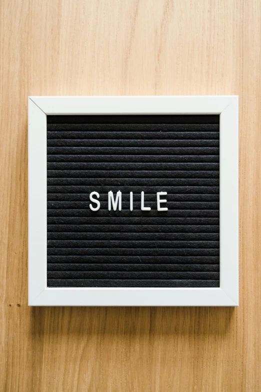 the word smile is engraved on the side of the picture