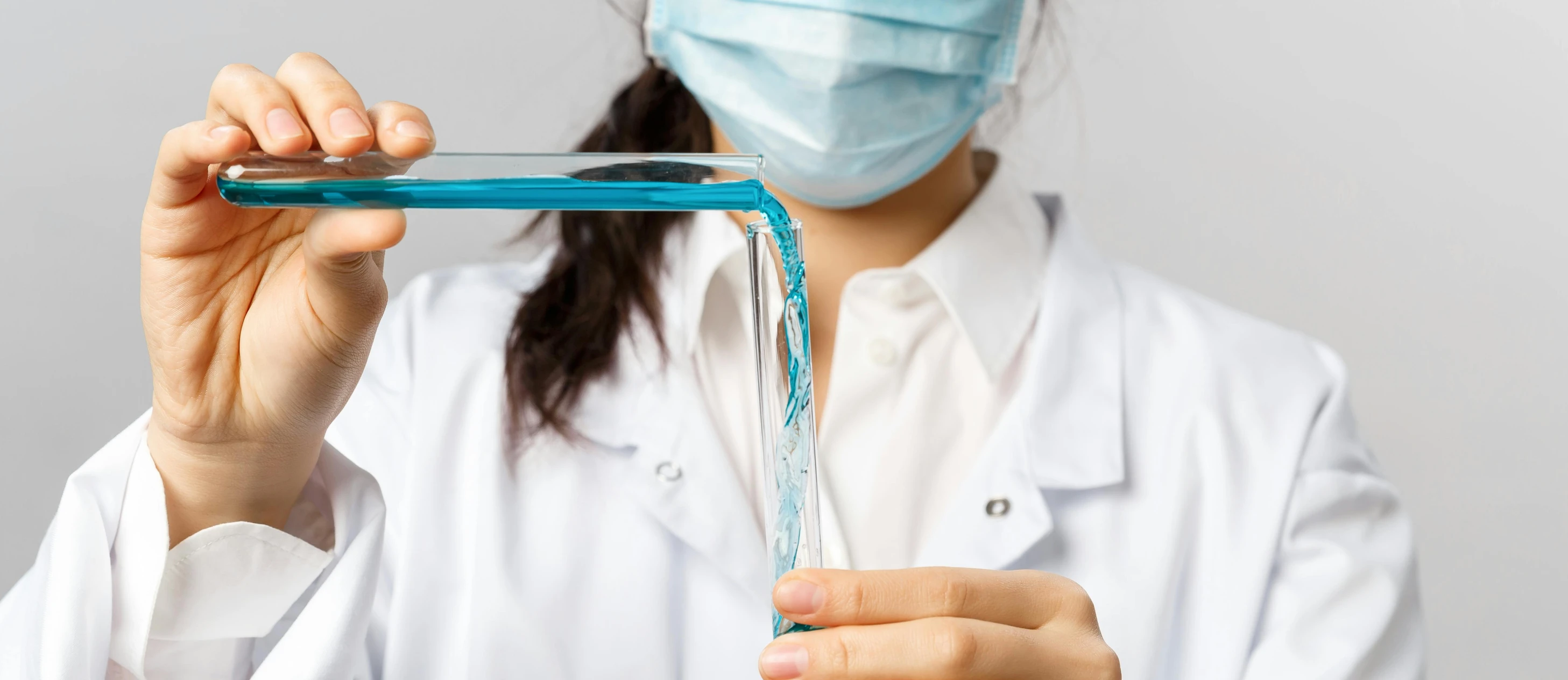 a female doctor holding up a medicine tube