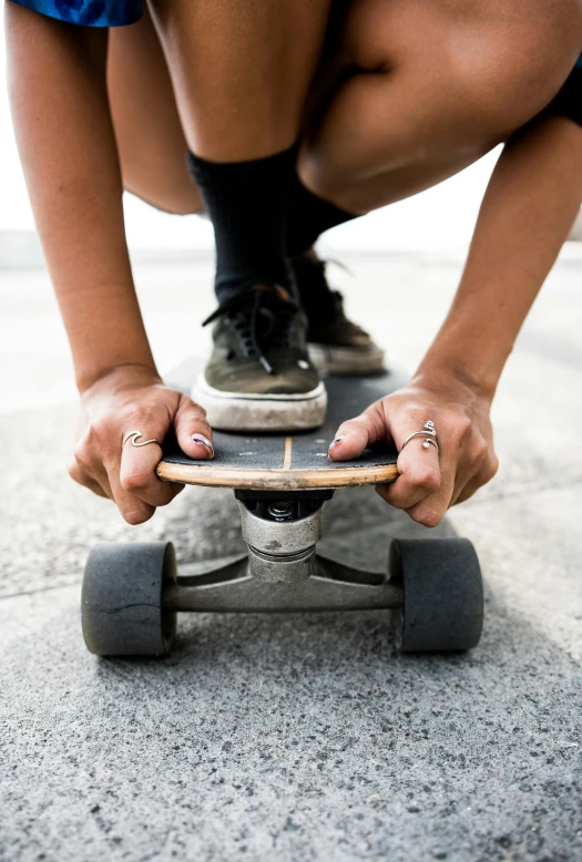 someone riding on top of a skateboard on the cement