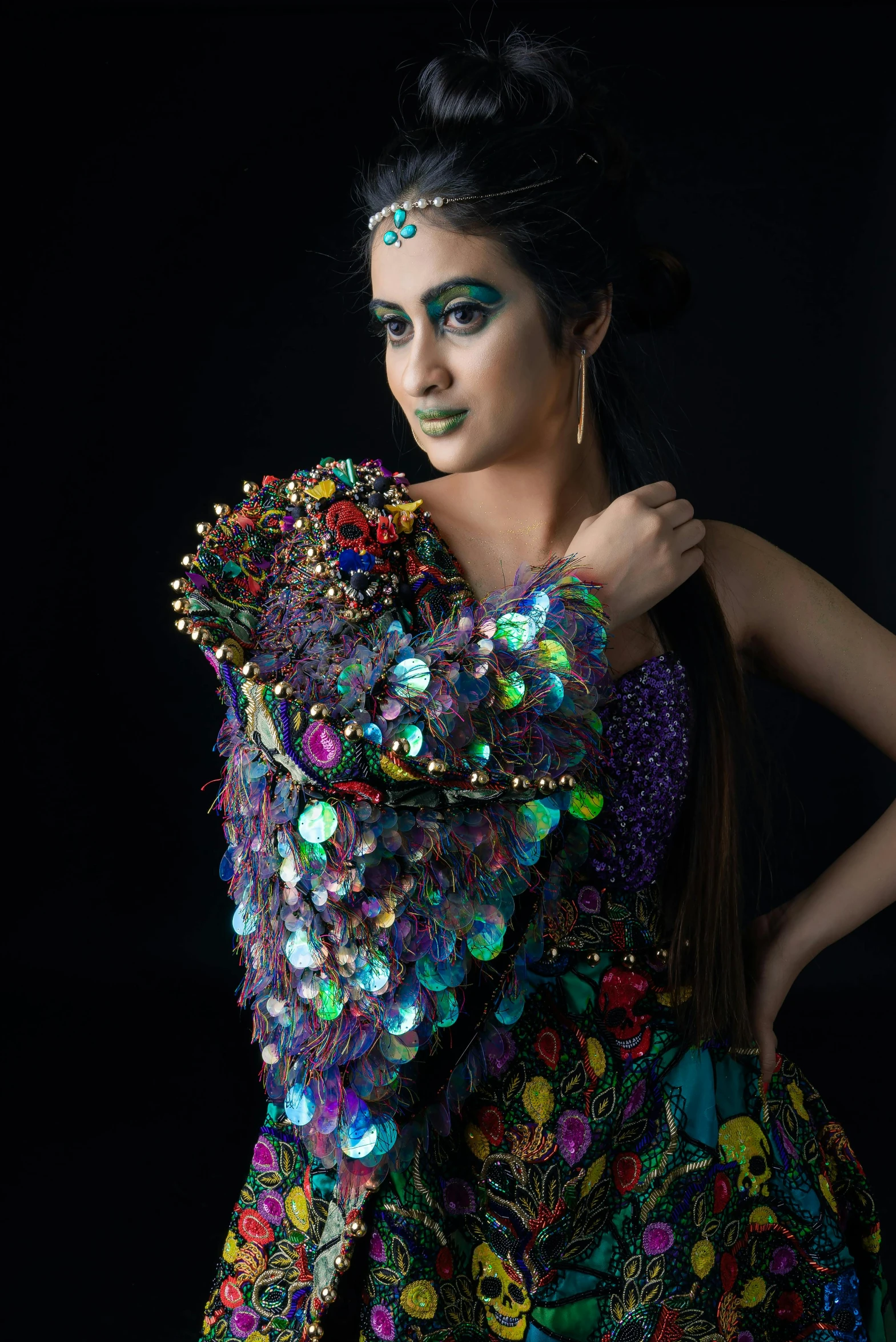 a beautiful young lady with makeup and hair, dressed in colorful clothing