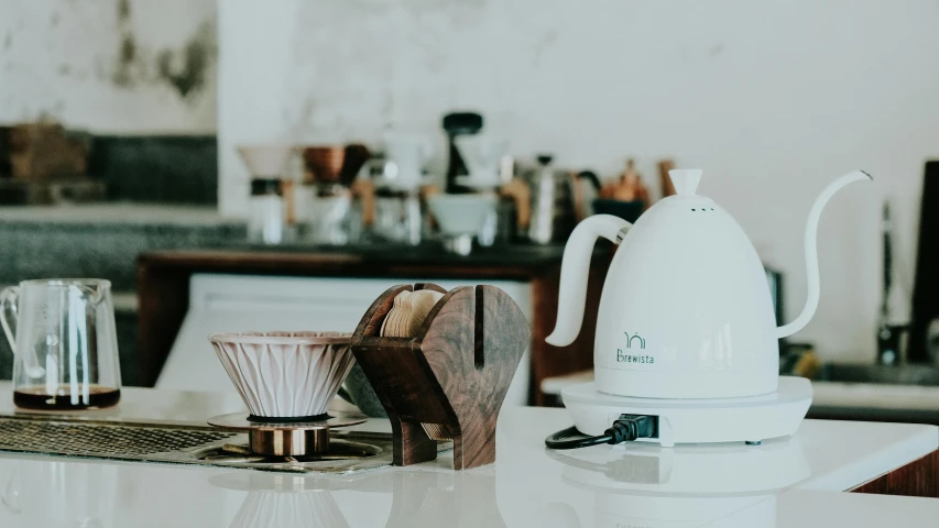 the top of the coffee kettle sits on the counter beside it