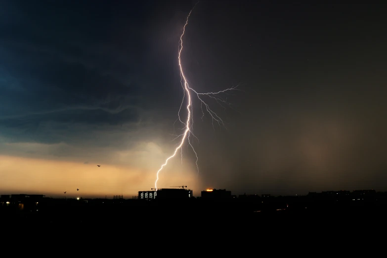 an amazing lightning strike caught from across the night sky