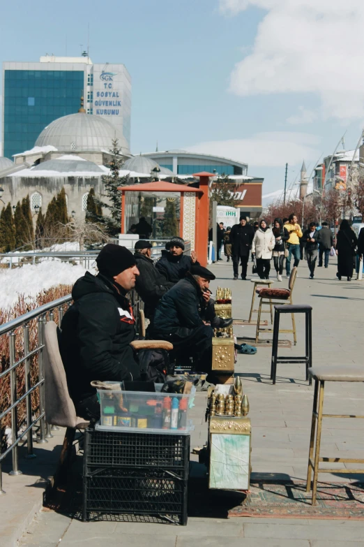 a group of people sitting on the ground outside