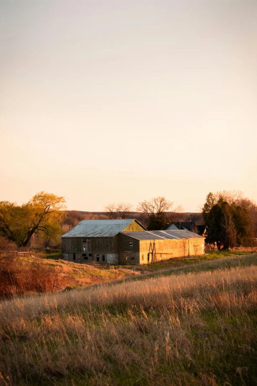 the lone barn sits on top of a hill