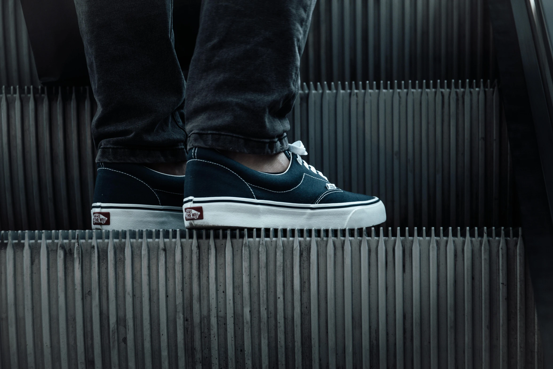 the top of a man's foot on an escalator