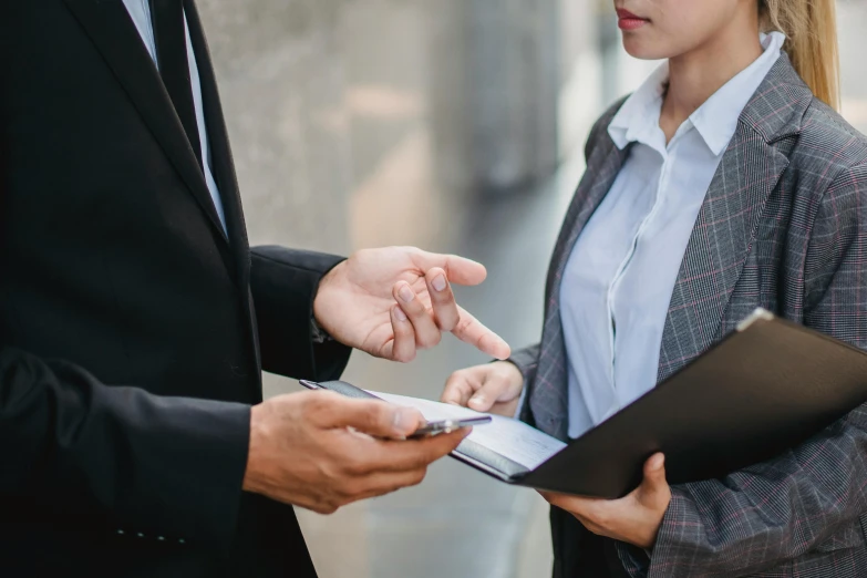 two business people having conversation together while on their cell phones