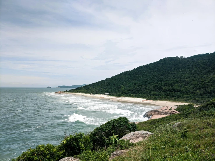 view of the ocean with rocks, trees and water