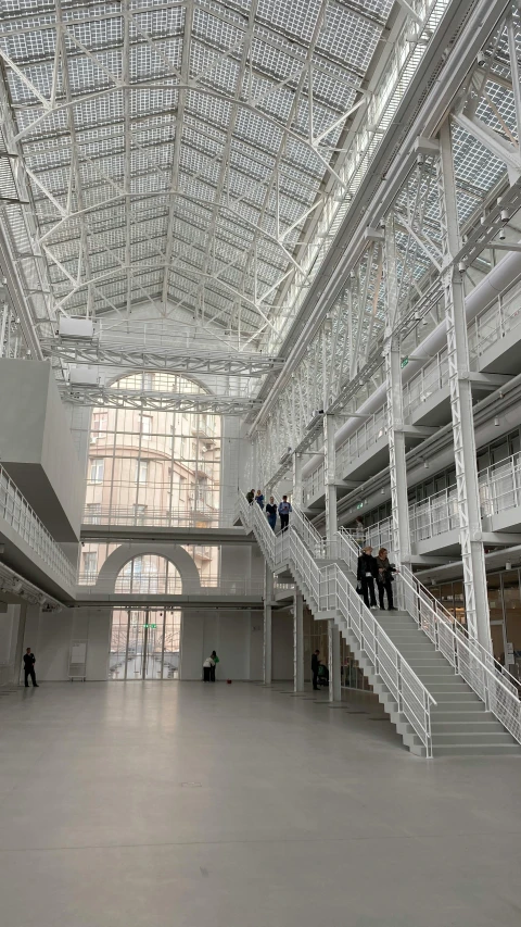 two people climbing down some steps inside a building