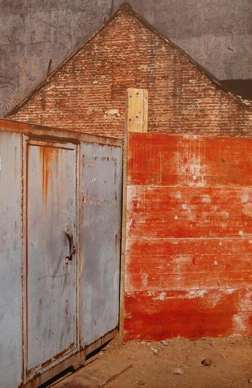 an old building has a rusty door to it