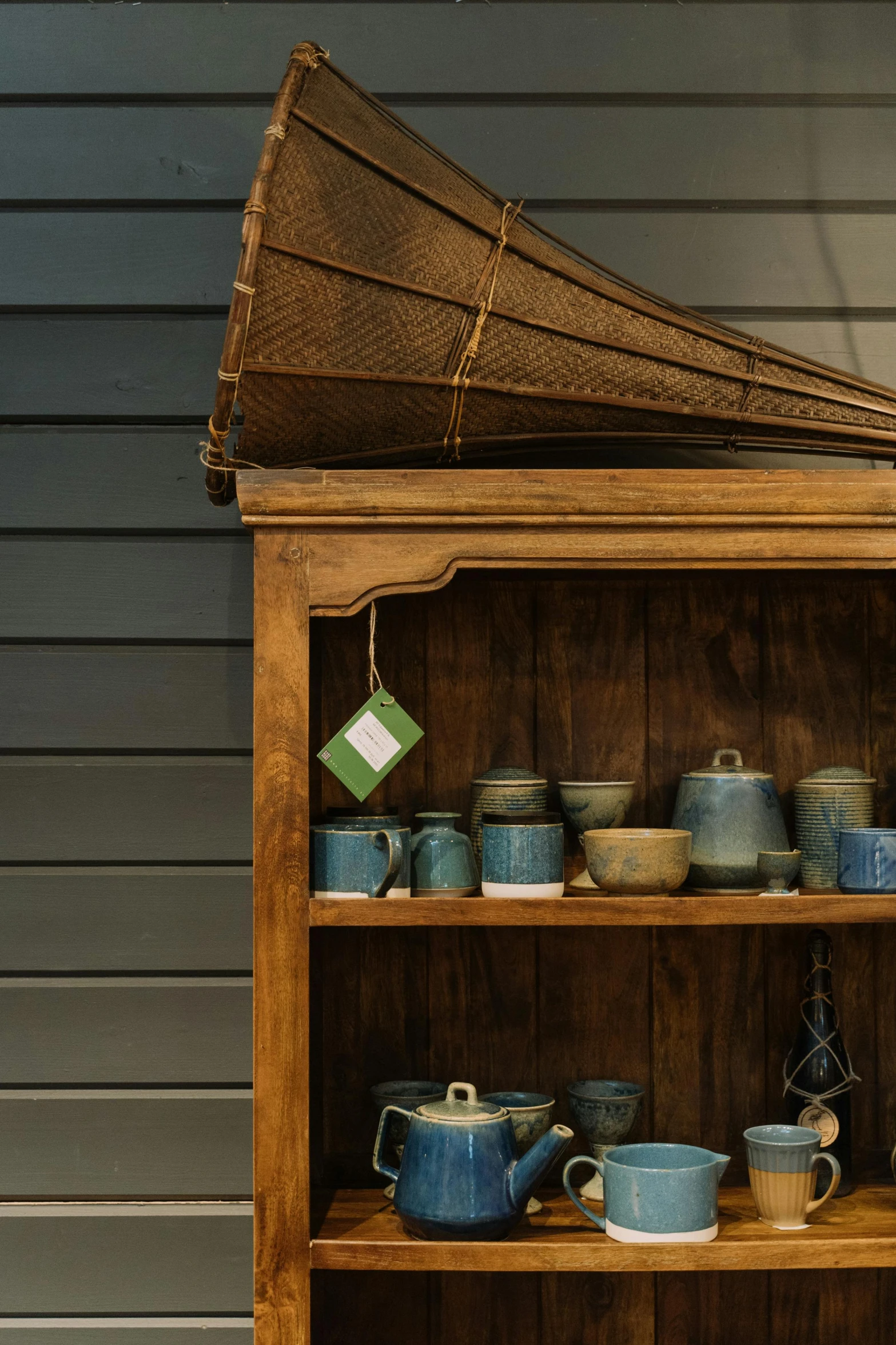 a shelf filled with different kinds of pots and pans