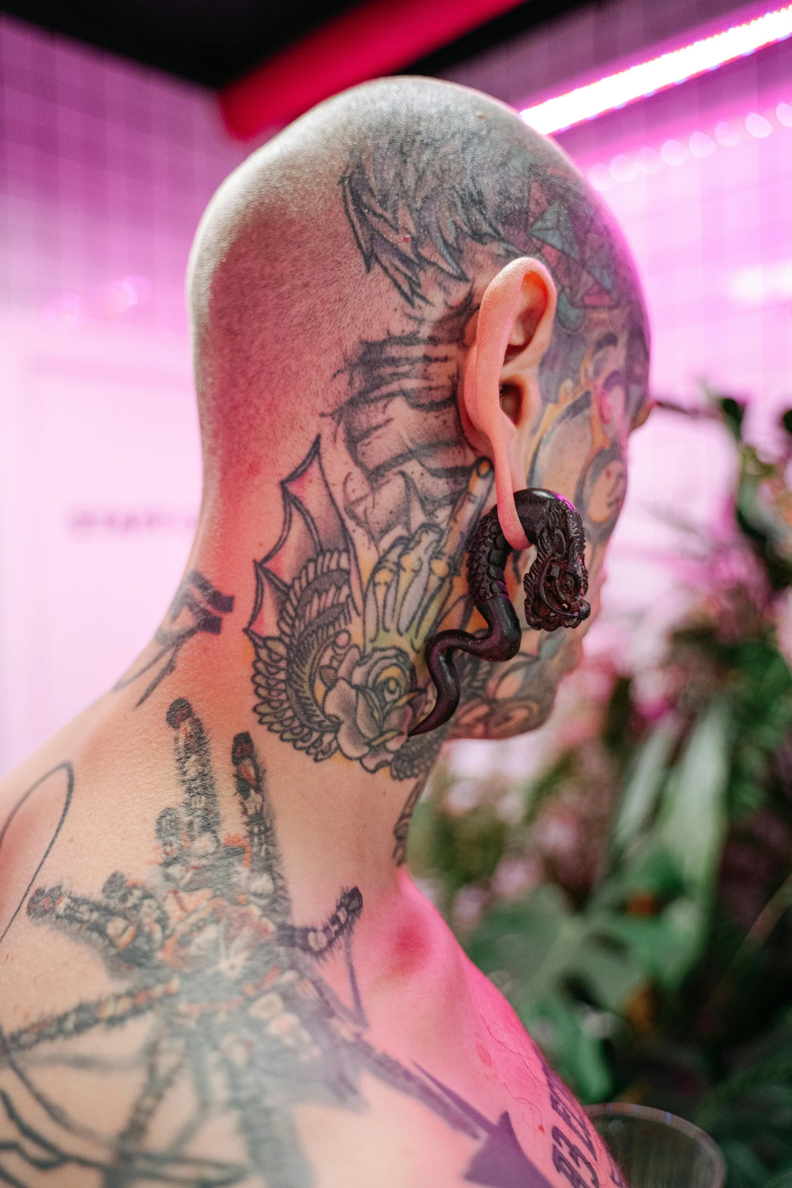 an tattooed man looks off to his side