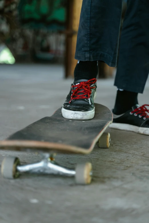 the skateboarder wears high - top sneakers with red laces on them