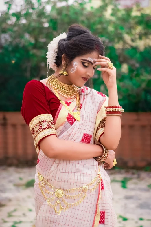 a young indian woman wearing a saree and jewelry