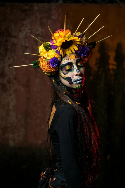 a woman in halloween makeup and flowers on her head