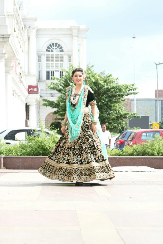 woman in a colorful outfit standing outdoors in the sun