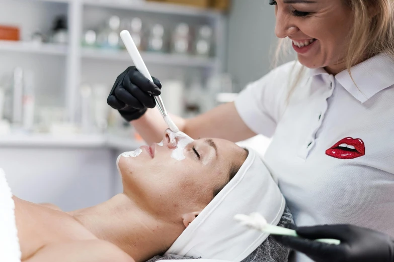 a woman getting her teeth brushed by a dentist