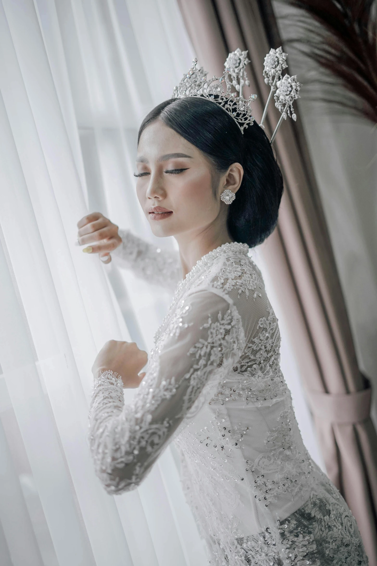 an asian woman dressed in a chinese bride style costume