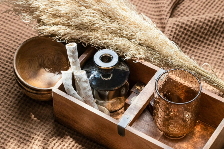 a wooden tray with a pitcher, glass and a small wooden bowl on a table