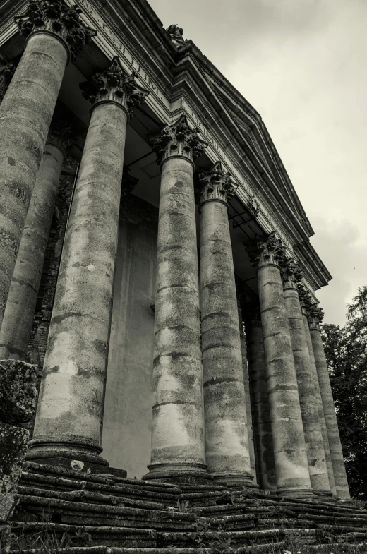 black and white pograph of pillars, and clock