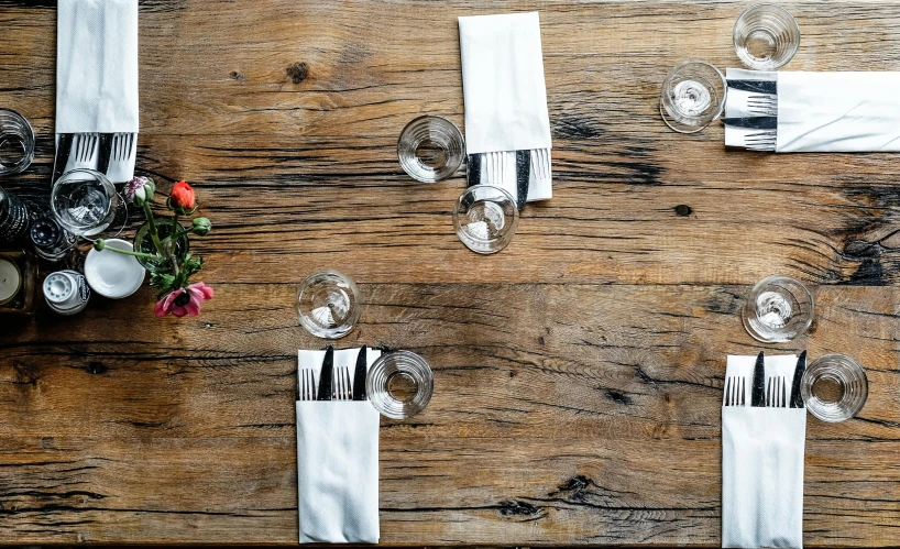 three place settings for empty glasses, place settings are set on an old wood table