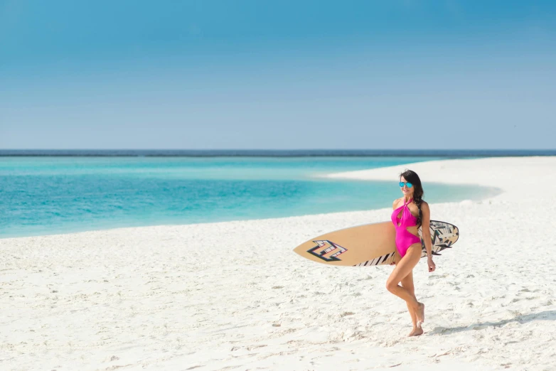 a woman is holding a surf board on the beach