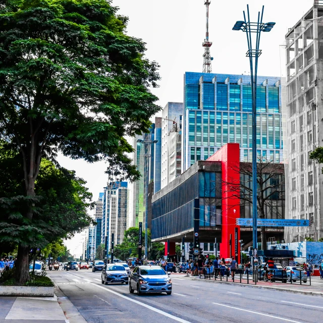 a large billboard is on the street and there are cars driving down it